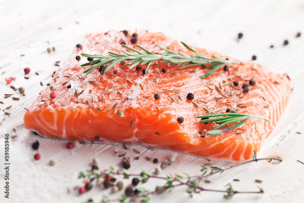 Salmon filet on a wooden carving board. Salmon filet on a wooden carving board.