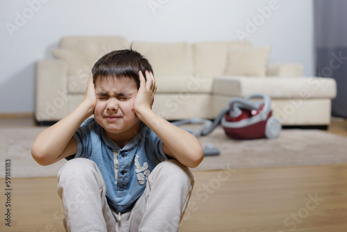 A child keeping his head and crying