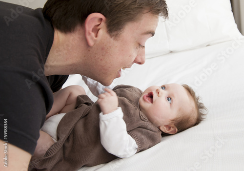 Young father playing with sweet baby girl