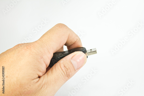 Flash drive in hand on white background