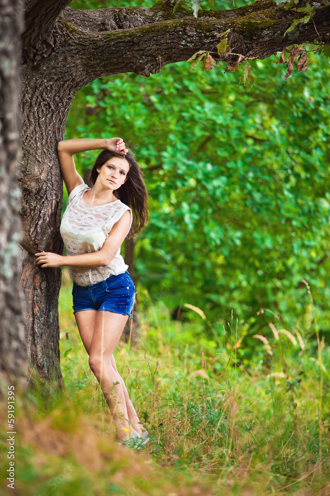 Fashion portrait of young sensual woman in garden Fashion portrait of young sensual woman in garden