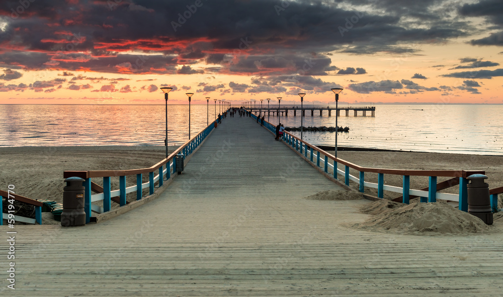 Fototapeta premium Sunset at a marine pier in resort city of Palanga