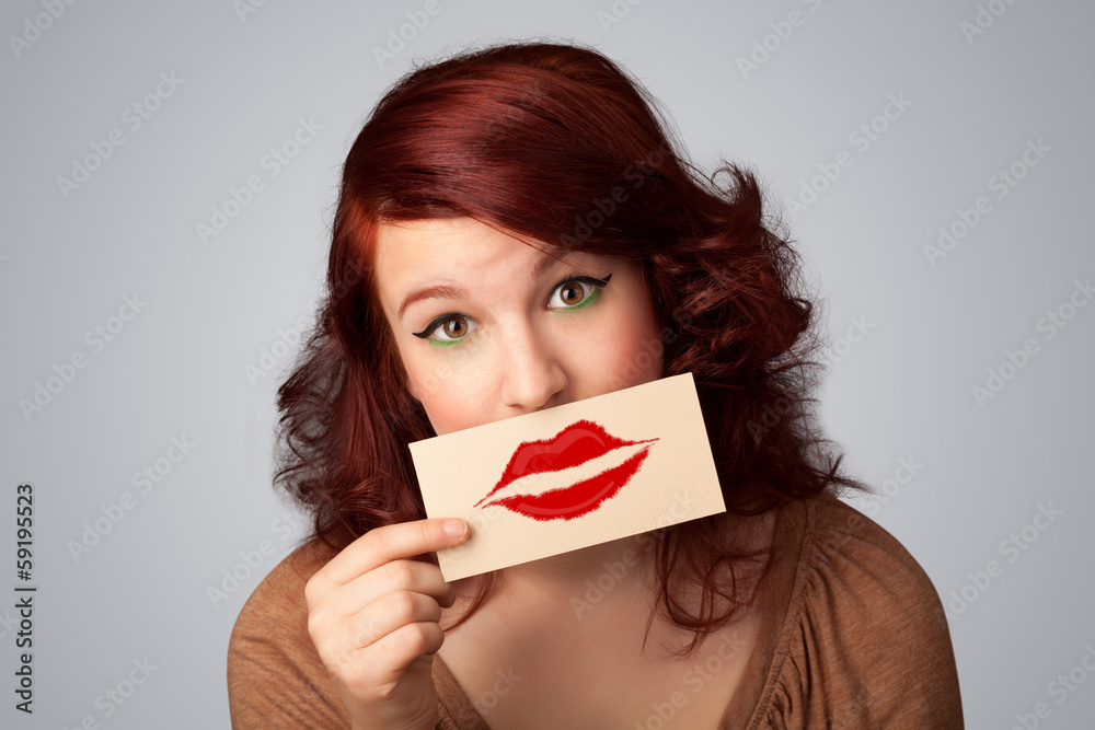 Happy pretty woman holding card with kiss lipstick mark Happy pretty woman holding card with kiss lipstick mark