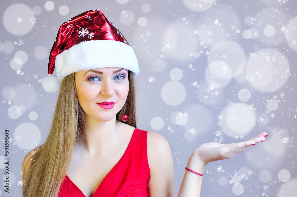 Beautiful christmas woman in santa hat with blank white board Beautiful christmas woman in santa hat with blank white board