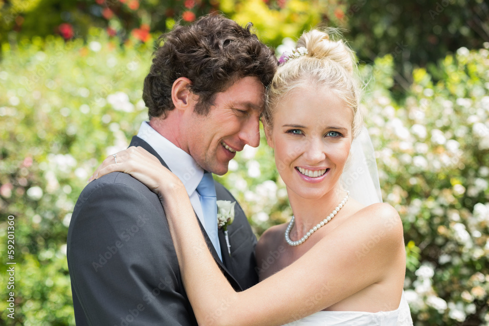 Romantic smiling newlyweds hugging each other Romantic smiling newlyweds hugging each other