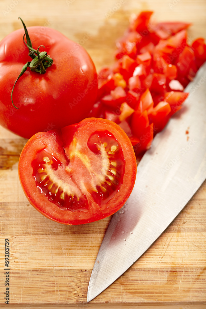 Freshly chopped tomatoes on a wooden board Freshly chopped tomatoes on a wooden board