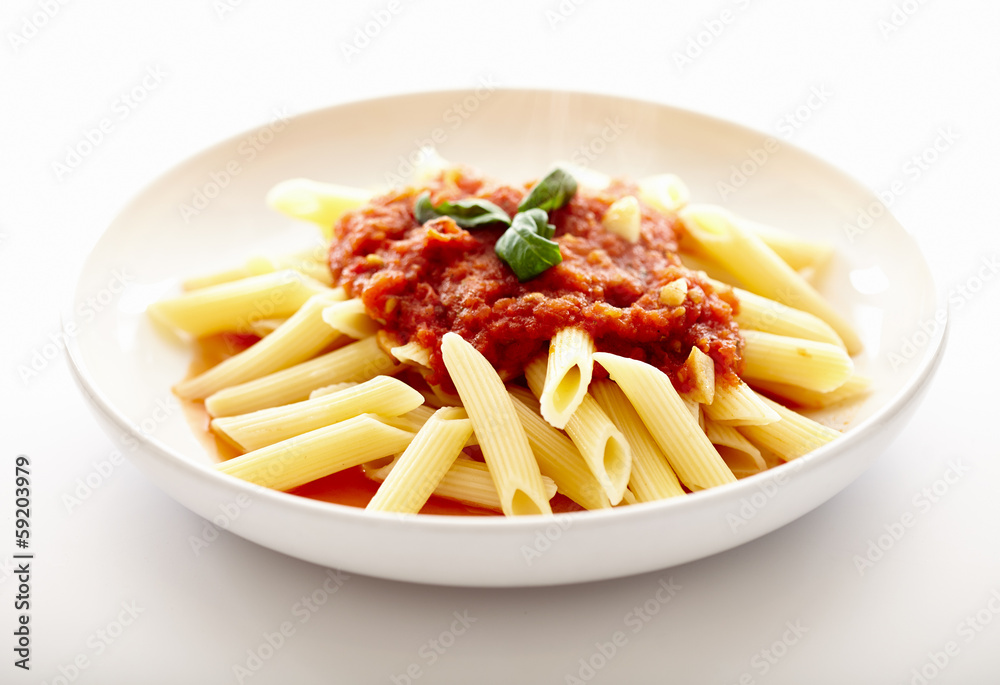 Traditional italian pasta with tomato sauce and basil Traditional italian pasta with tomato sauce and basil