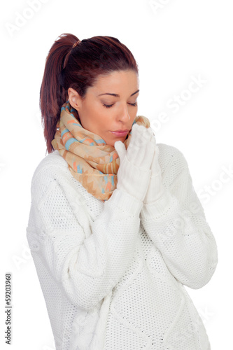 Pretty woman with gloves and scarf warming up hands