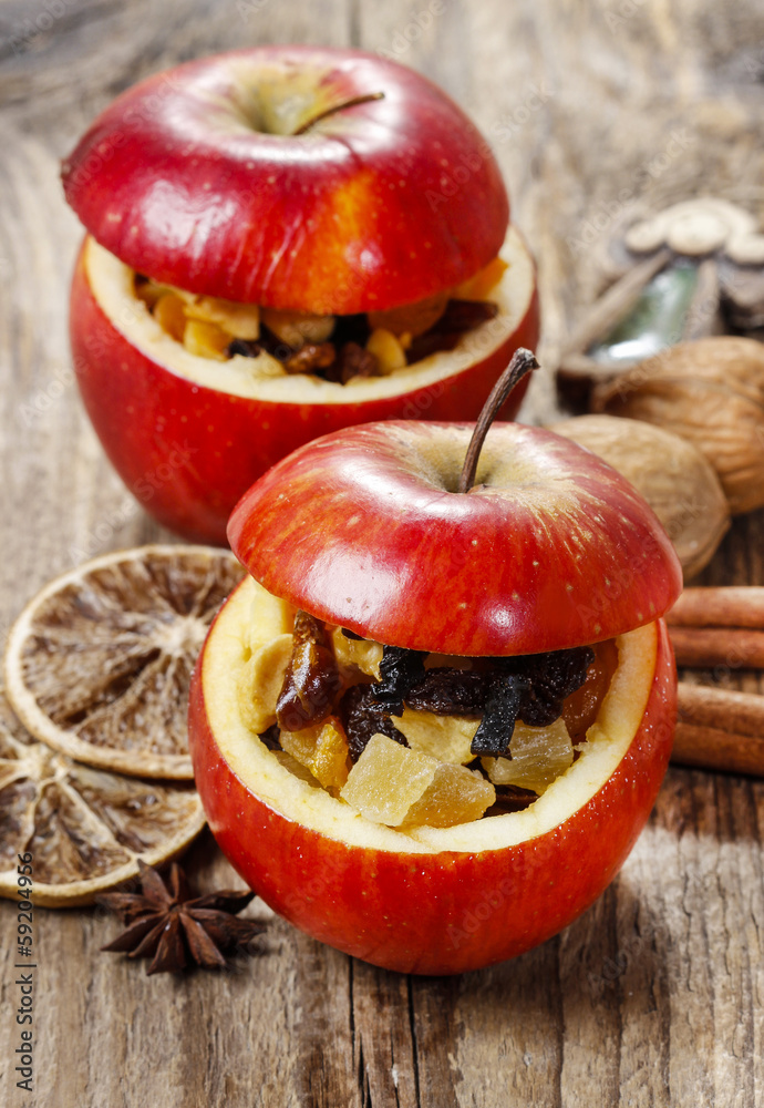 Red christmas apples stuffed with dried fruits in honey