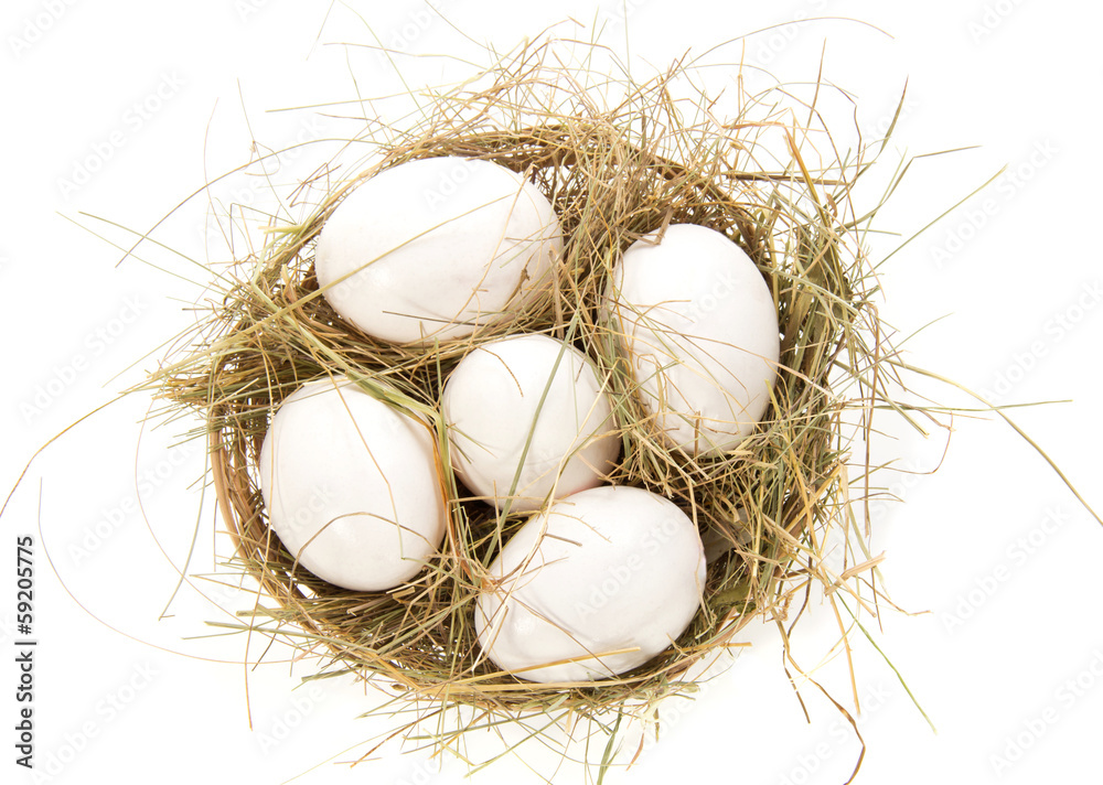 White eggs, hay in a bast basket White eggs, hay in a bast basket