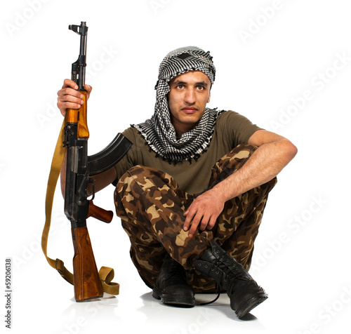 Arab nationality in camouflage suit and keffiyeh with automatic