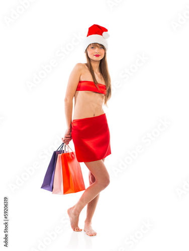 Beautiful Santa christmas girl with shopping bags on white