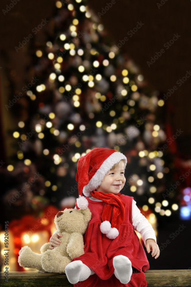 little girl with christmas hat and teddy bear on black little girl with christmas hat and teddy bear on black