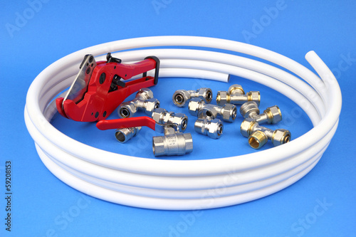 The pex pipe and armature on the blue background