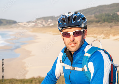 Cyclist in nature looking at camera