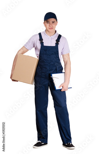 Young delivery man in blue overalls and blue peaked cap