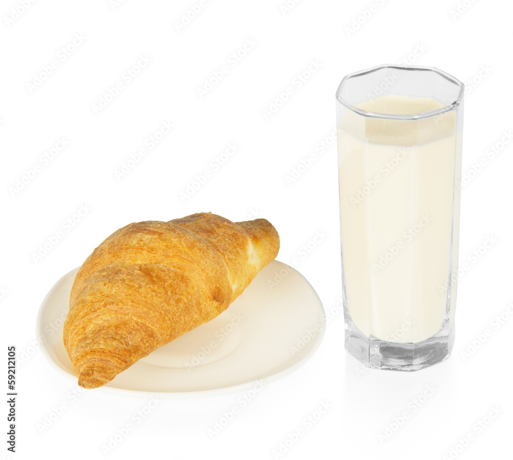 Croissant on a saucer and the glass of milk Croissant on a saucer and the glass of milk