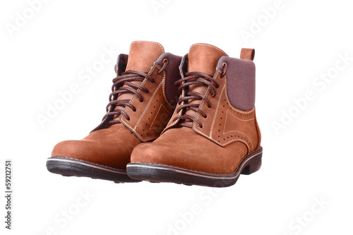A pair of new brown hiking boots on white background