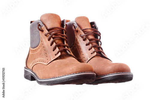 A pair of new brown hiking boots on white background