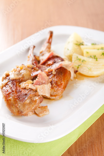 Marinated rabbit with bacon and boiled potatoes