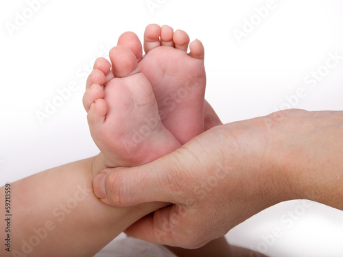 Mother hands holding baby feet