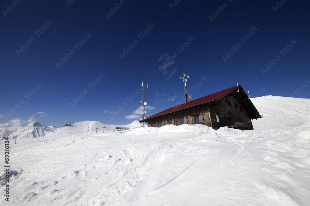 Wooden hotel at snowy mountains