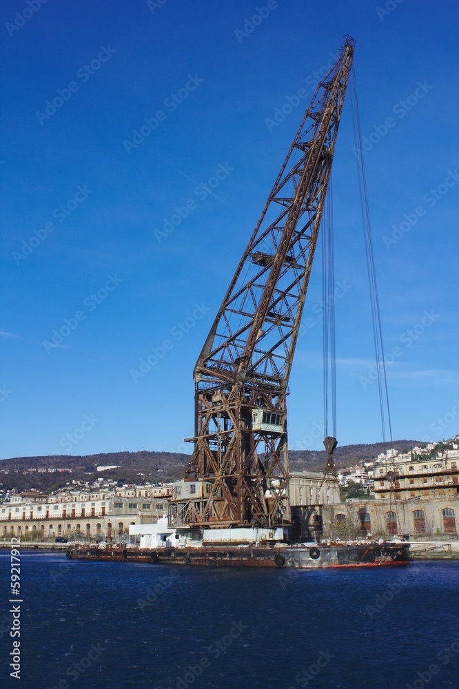 Old floating crane moored in the port of Trieste, Italy Old floating crane moored in the port of Trieste, Italy