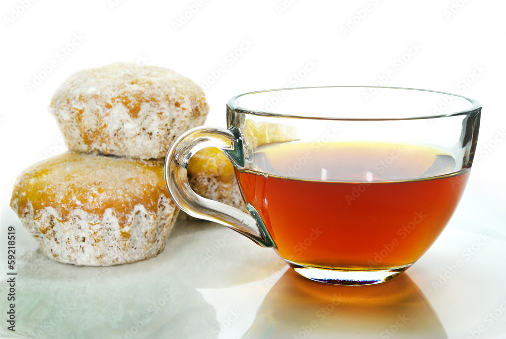 Tea, muffins in powdered sugar isolated on a white background. Tea, muffins in powdered sugar isolated on a white background.