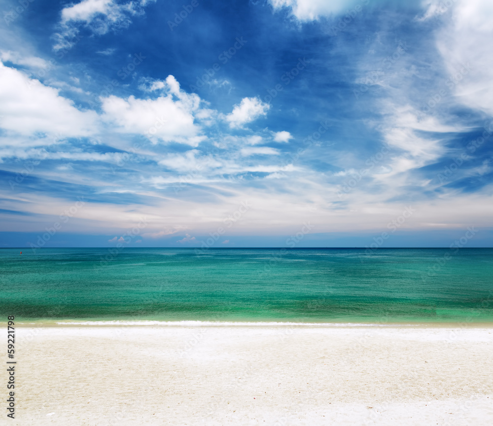 Clear water and blue sky. White sand beach