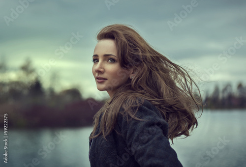 Outdoor portrait of young girl with beautiful eyes © kiuikson