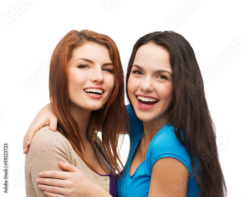 two laughing girls hugging