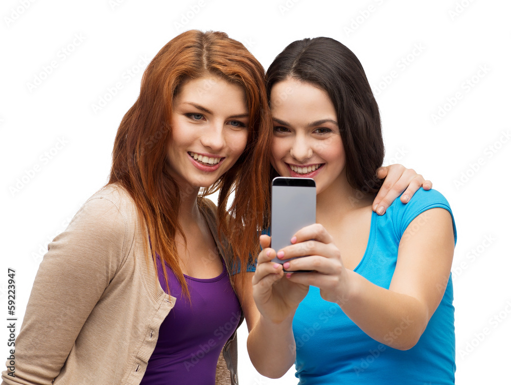 two smiling teenagers with smartphone two smiling teenagers with smartphone