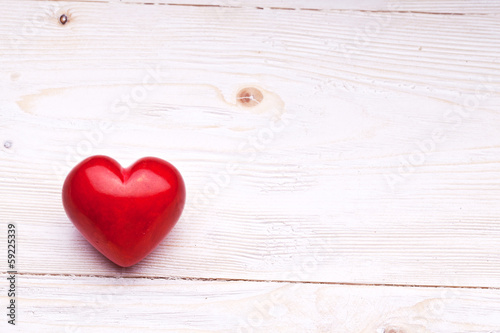 Valentines Day. Red heart on a wooden table.