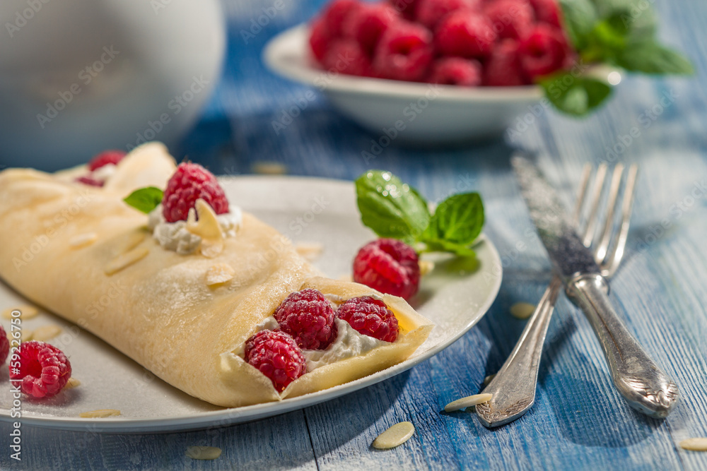 Raspberry pancakes served with whipped cream