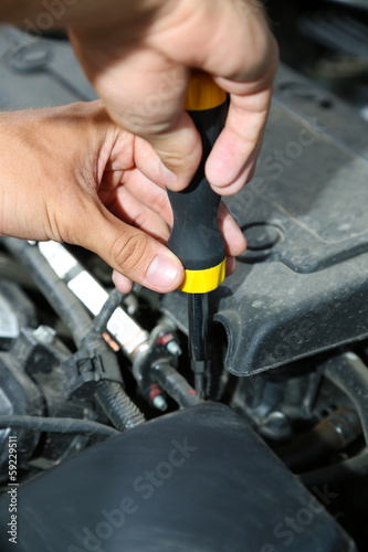 Hand with screwdriver. Auto mechanic in car repair © Africa Studio