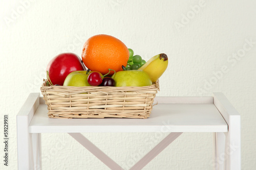 Fototapeta Naklejka Na Ścianę i Meble -  Fruit on white shelf on grey wall background