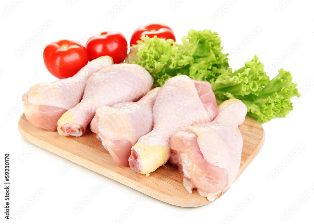 Raw chicken legs on wooden board isolated on white Raw chicken legs on wooden board isolated on white