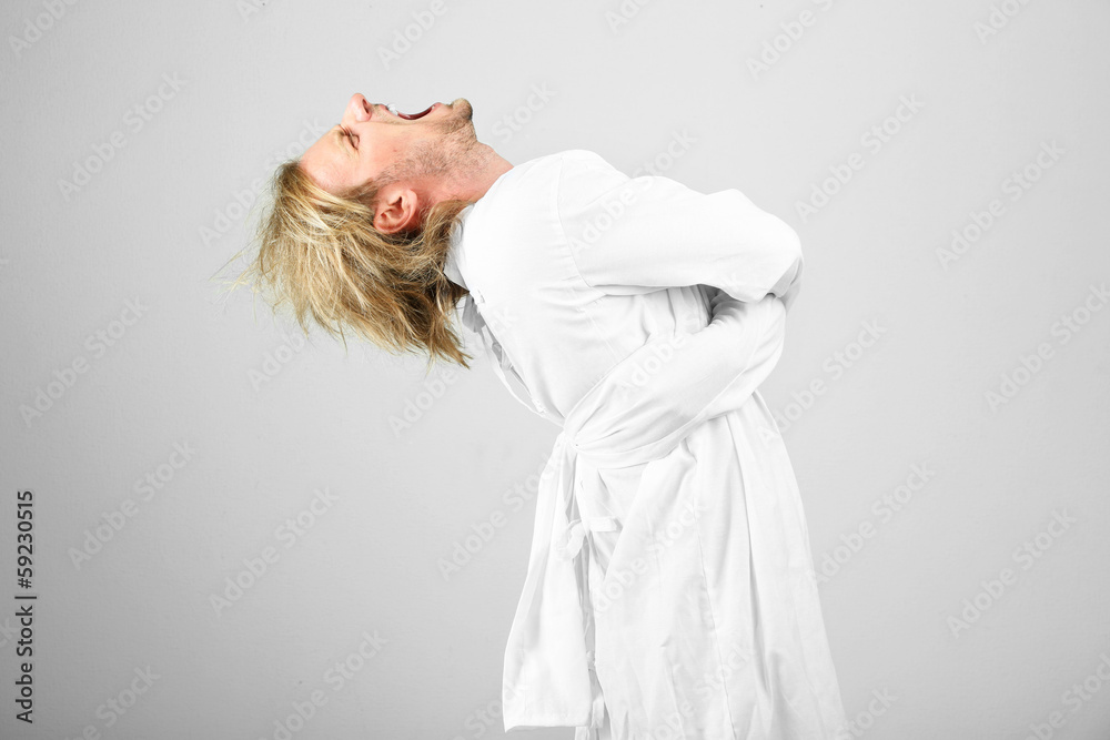 Mentally ill man in strait-jacket on gray background Mentally ill man in strait-jacket on gray background