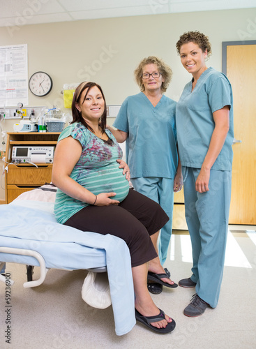 Female Nurses With Pregnant Woman In Hospital Room © Tyler Olson