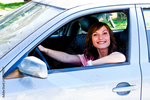 young and beautiful woman driving a car