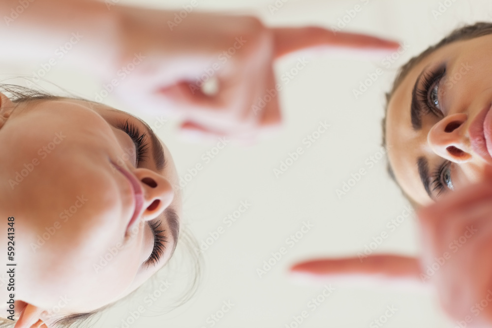 Low angle view of angry young females having an argument Low angle view of angry young females having an argument