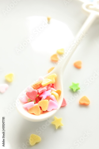 heart shaped candy on spoon for background image