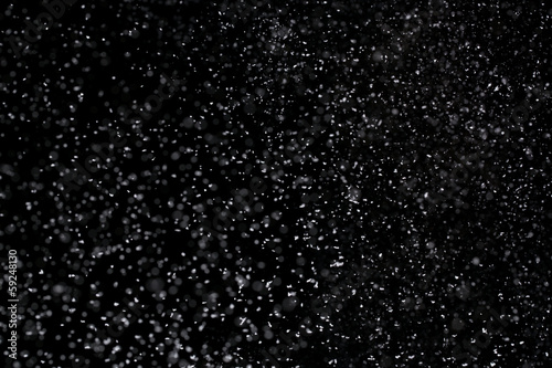 Falling snow isolated on pure black background