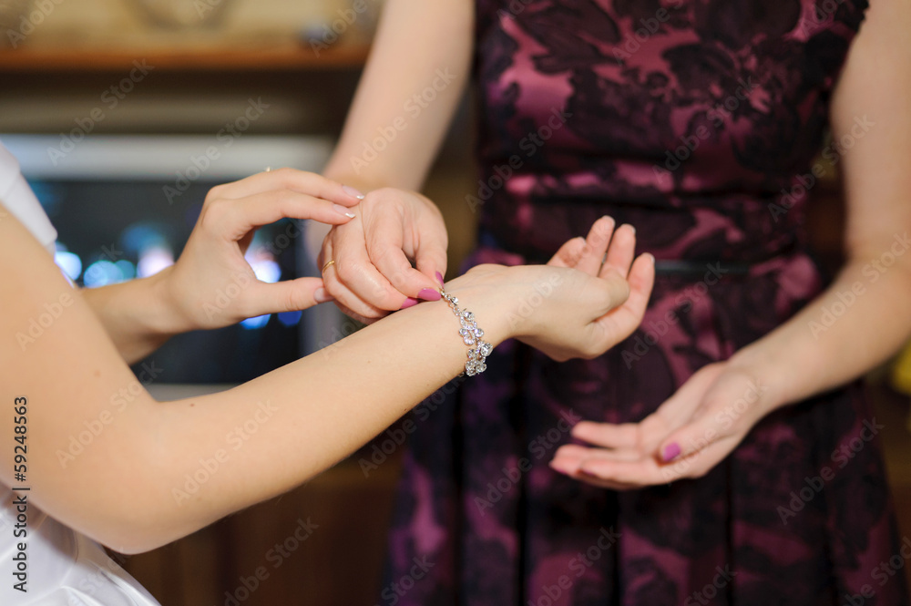 Fototapeta premium Putting on Bracelet with Crystals