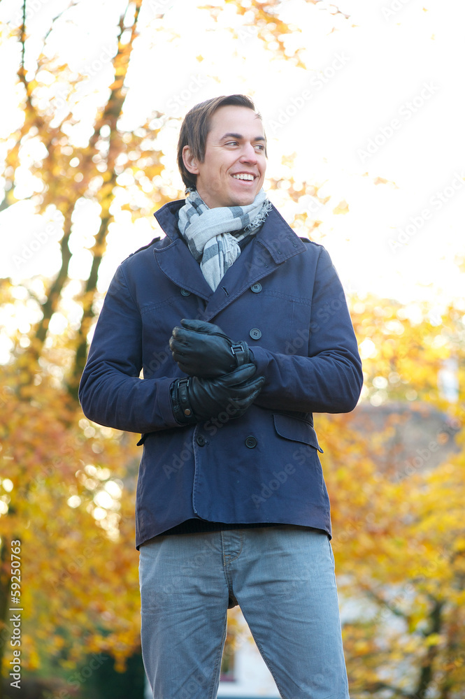 Happy man standing outdoors on an Autumn day