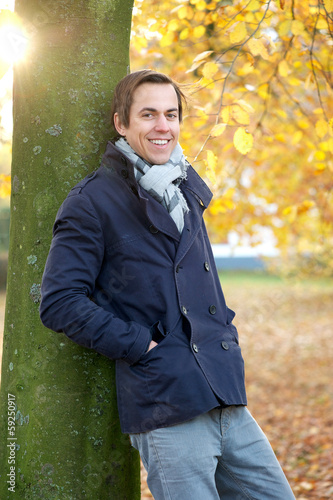 Relaxed man smiling outdoors on an Autumn day © mimagephotos
