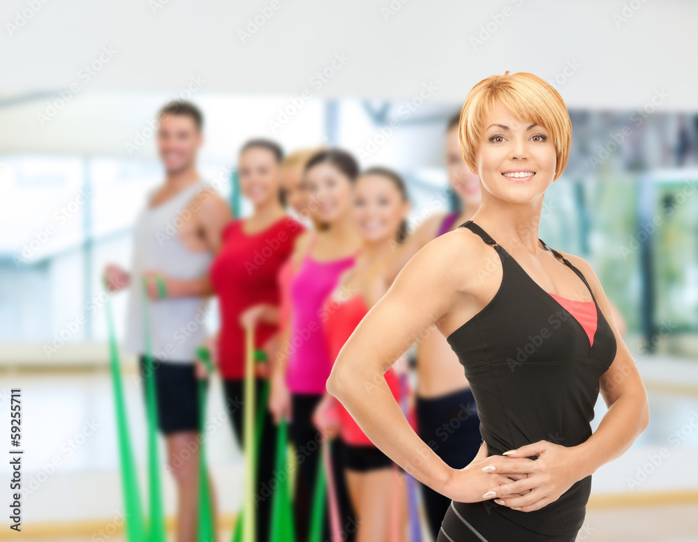 group of smiling people exercising in the gym group of smiling people exercising in the gym