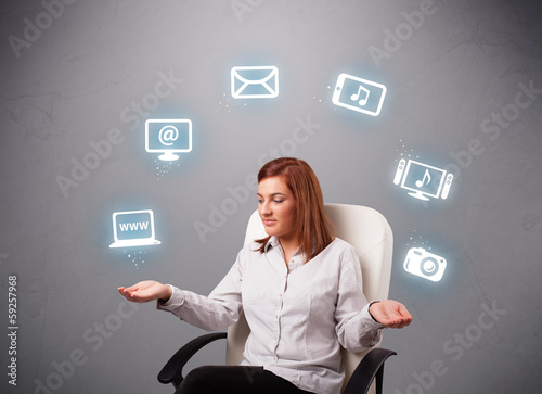 pretty girl juggling with elecrtonic devices icons photo