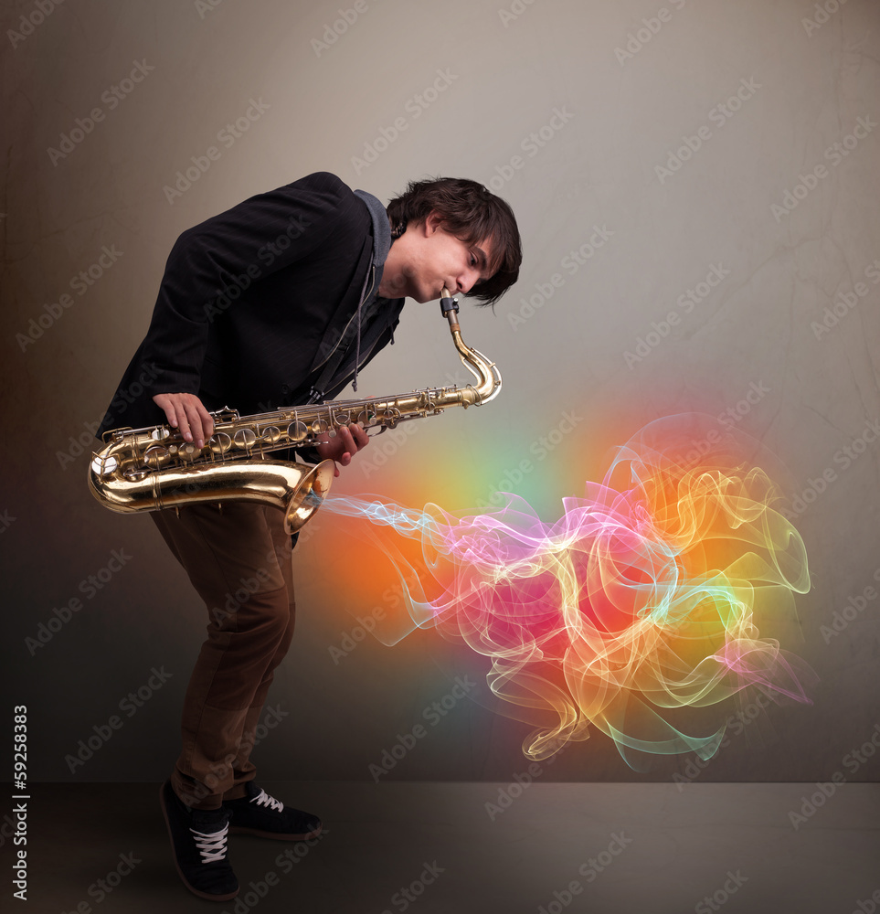 Naklejka premium Attractive musician playing on saxophone with colorful abstract