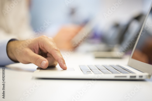 Close-up of businessman hands typing on laptop in Office